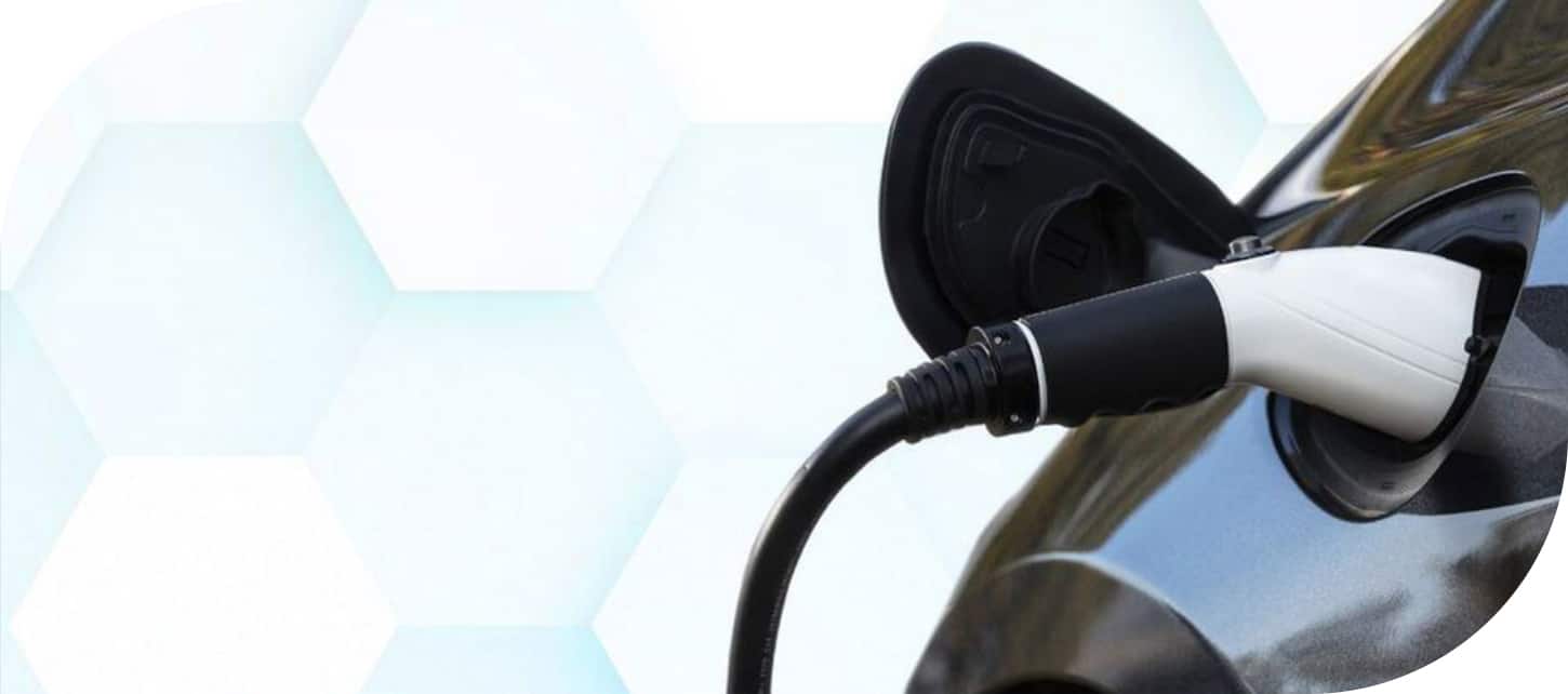 A charging cord plugged into the charging port of the 2026 Chrysler Pacifica Plug-in Hybrid.