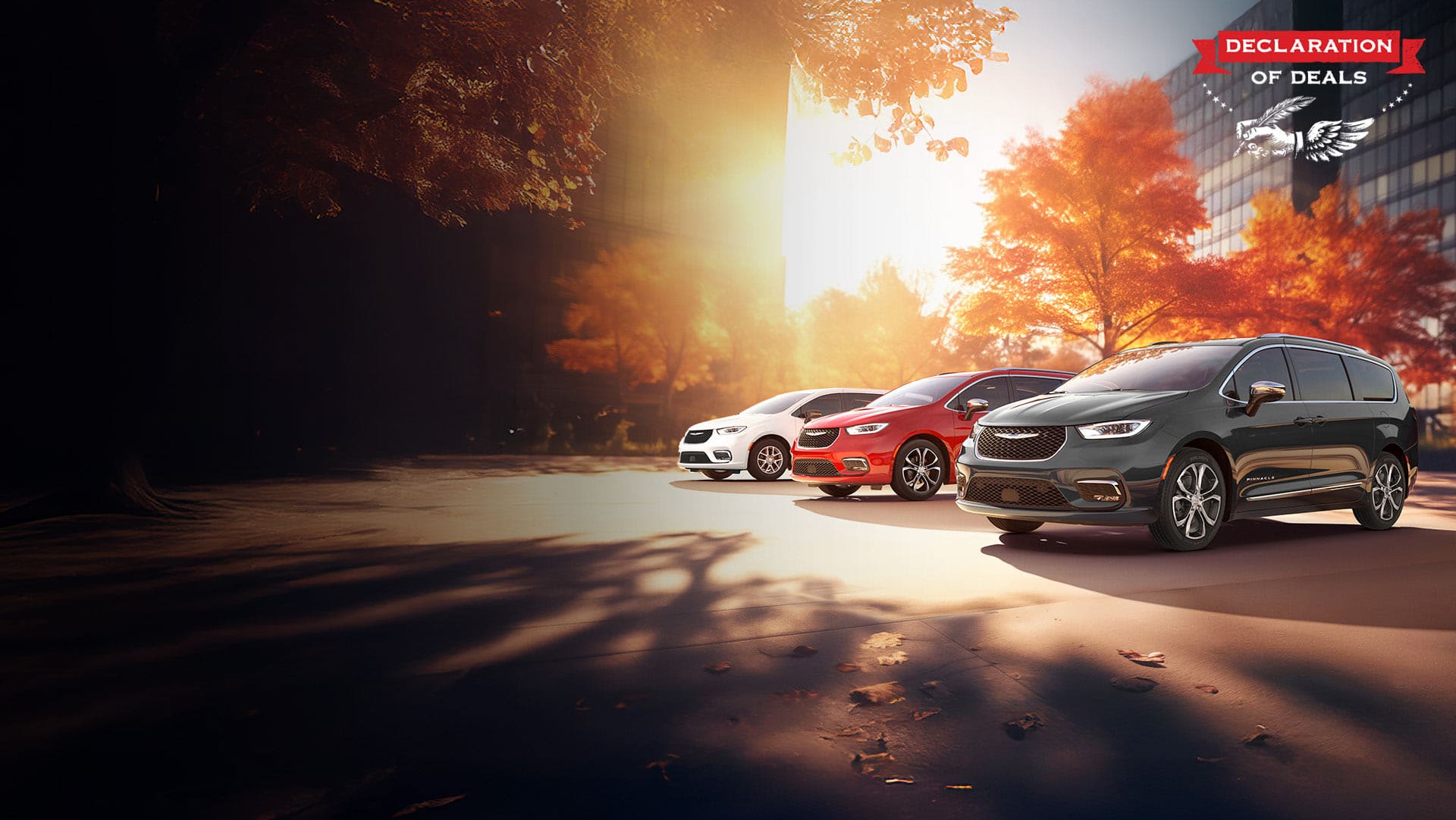Three 2026 Chrysler minivan models parked on an oceanside beach. From left to right: a white Chrysler Voyager, a blue Pacifica Pinnacle Plug-in Hybrid and a red Pacifica Pinnacle. Declaration of Deals Sales Event.