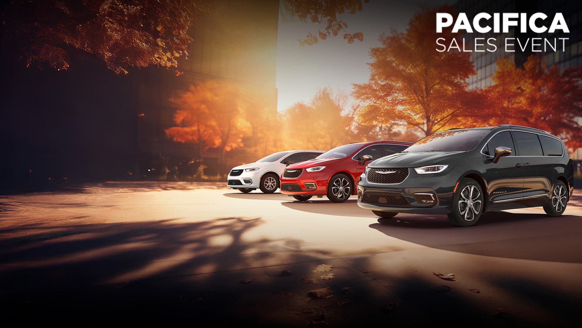 Three 2026 Chrysler minivan models parked on an oceanside beach. From left to right: a white Chrysler Voyager, a blue Pacifica Pinnacle Plug-in Hybrid and a red Pacifica Pinnacle. Chrysler Pacifica sales event.