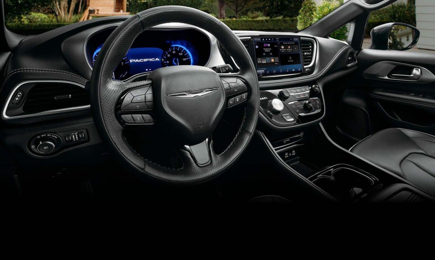 El volante, la pantalla del tablero de instrumentos digital y la pantalla táctil Uconnect en la Chrysler Pacifica Hybrid 2025 enchufable.