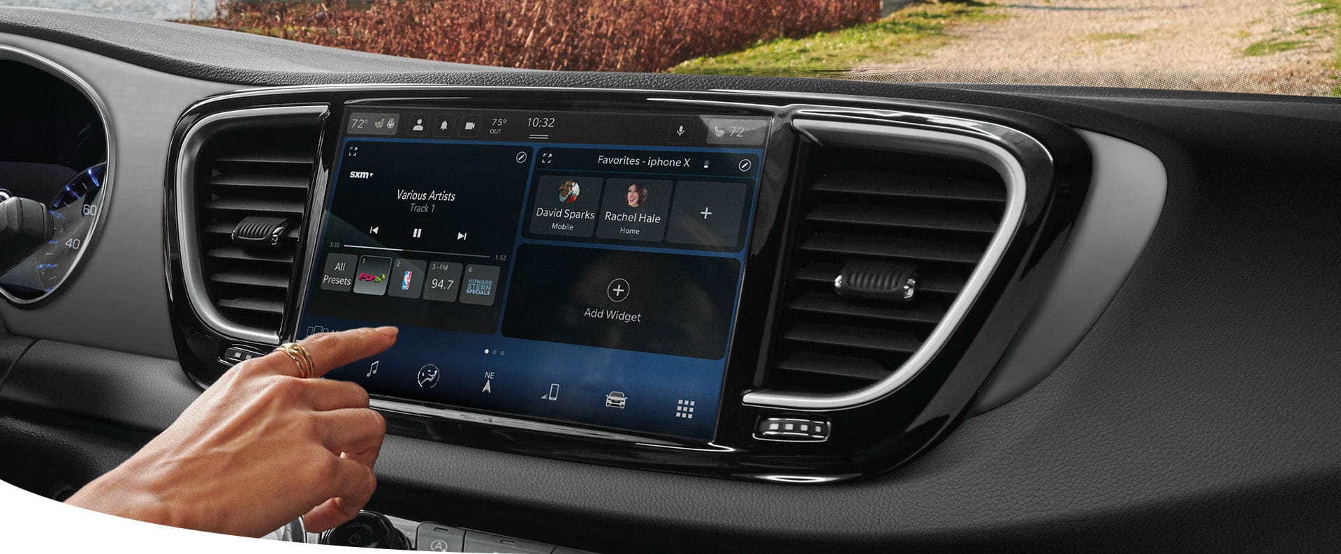 A female driver in a 2025 Chrysler Voyager LX making a music selection on the Uconnect touchscreen.