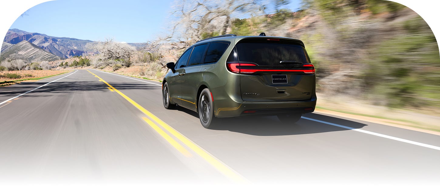 A driver-side rear angle of a an olive green 2027 Chrysler Pacifica Limited with the S Appearance Package, traveling down a highway.