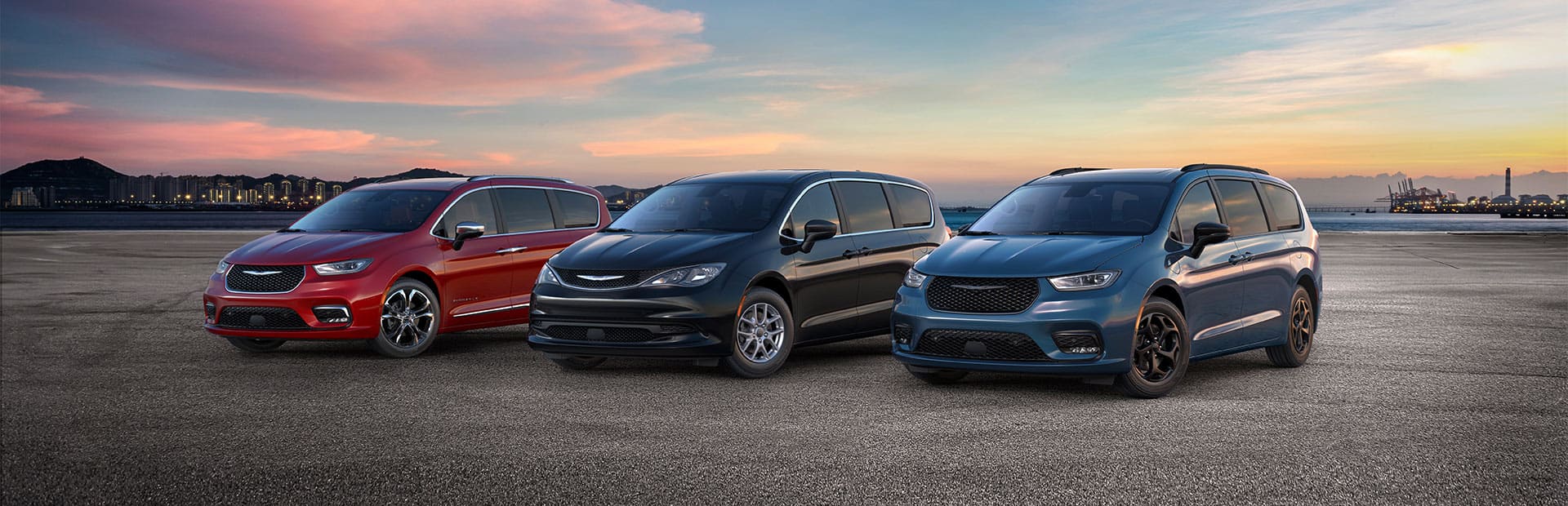 The 2025 Chrysler Brand minivan lineup: from left to right, a red Chrysler Pacifica Pinnacle, a black Chrysler Voyager LX and a blue Chrysler Pacifica Hybrid Select with the Premium S Appearance Package.